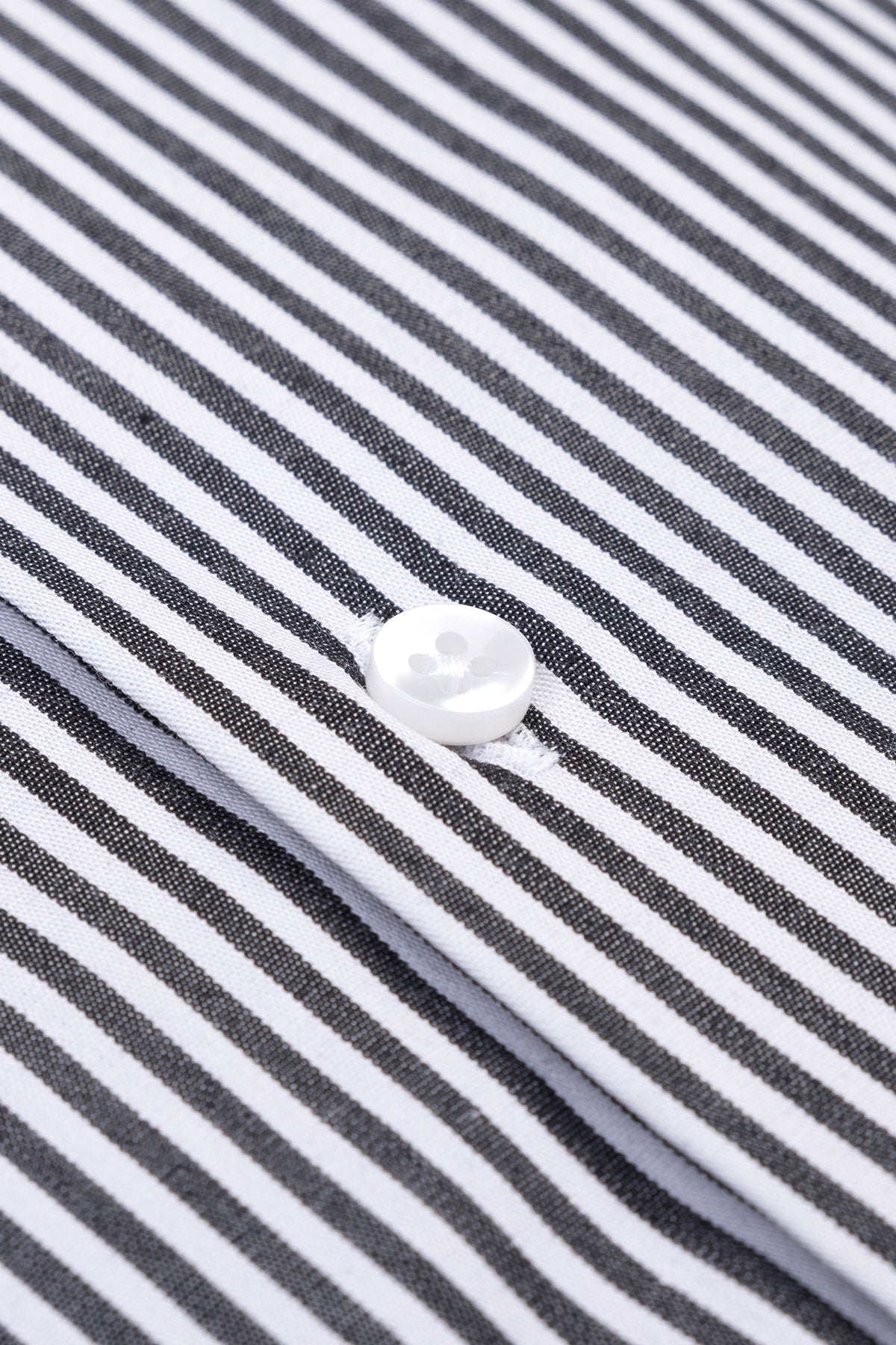 Gros plan sur le coton satiné de la chemise, mettant en valeur la texture douce.