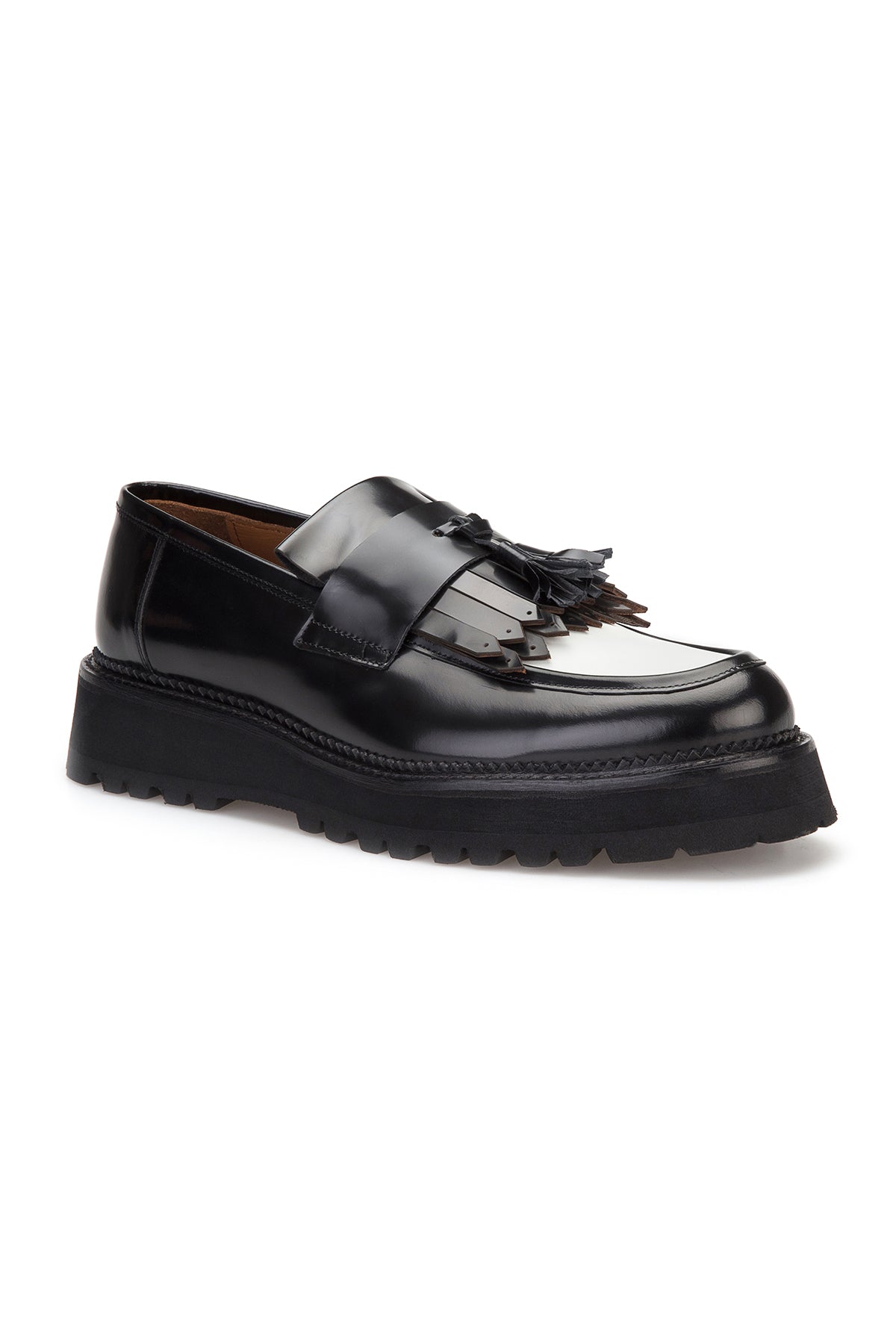 Detail of the loafer's decorative fringe along the edge.