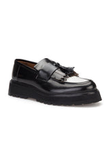 Detail of the loafer's decorative fringe along the edge.