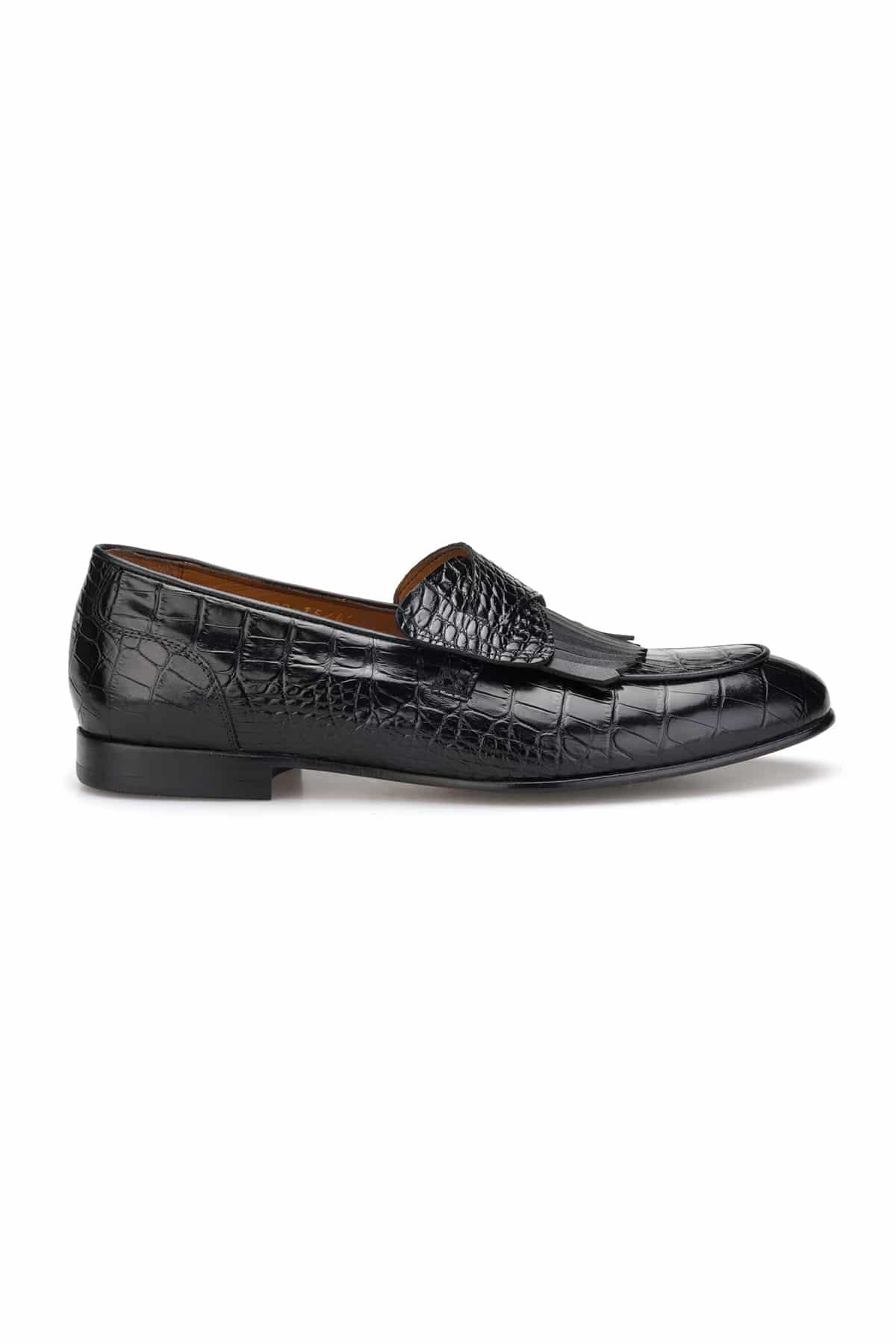 Vue latérale du mocassin à bout rond avec semelle d'usure cuir et caoutchouc.
