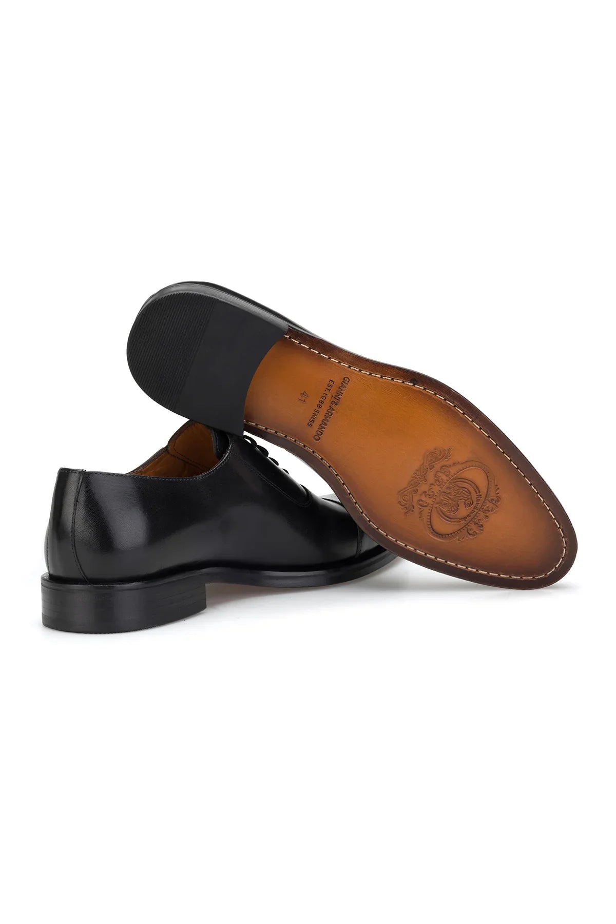 Modell trägt schwarze Herren Business-Schuhe in Business-Umgebung